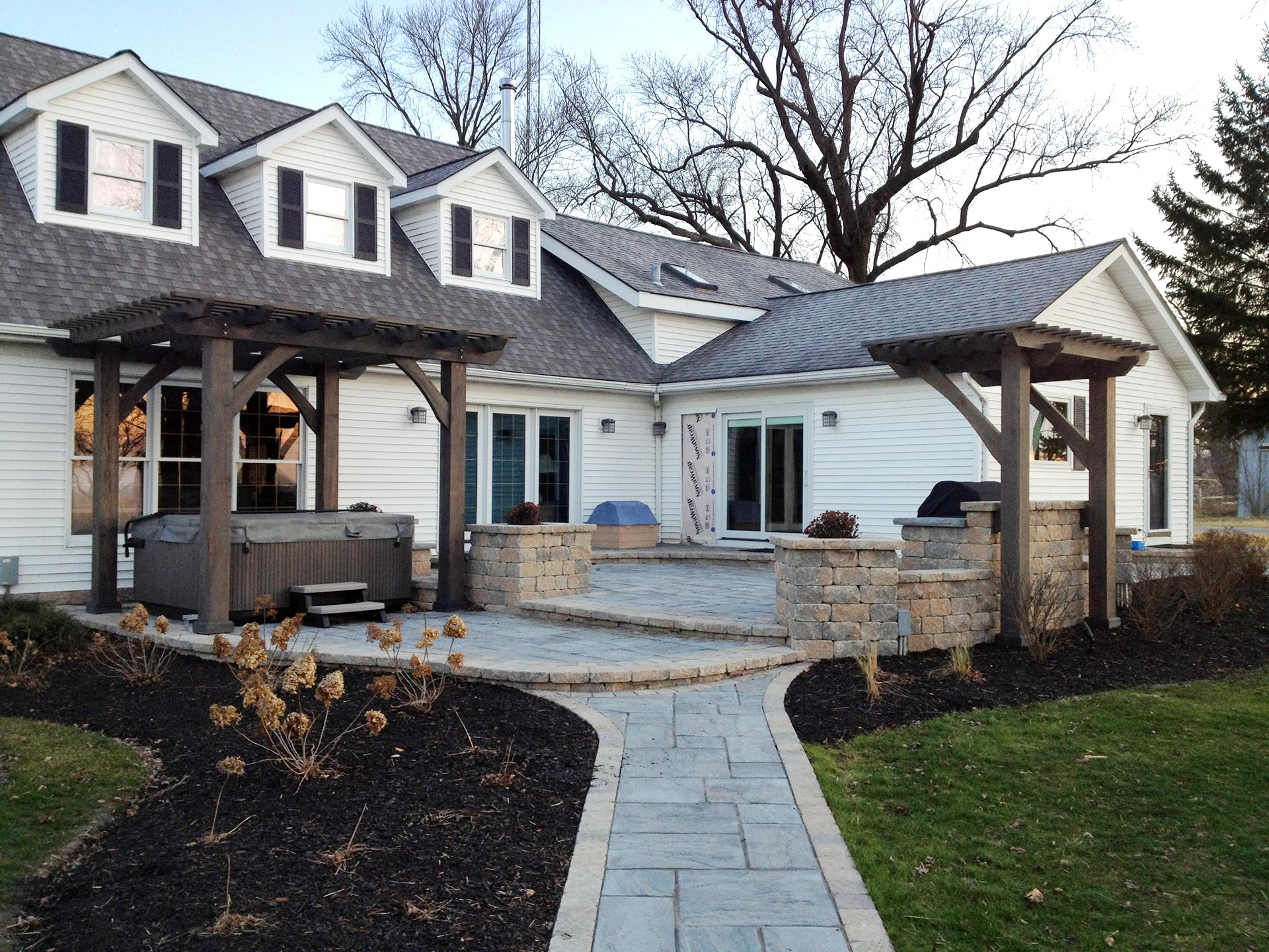 stone walkway with two wooden pergolas